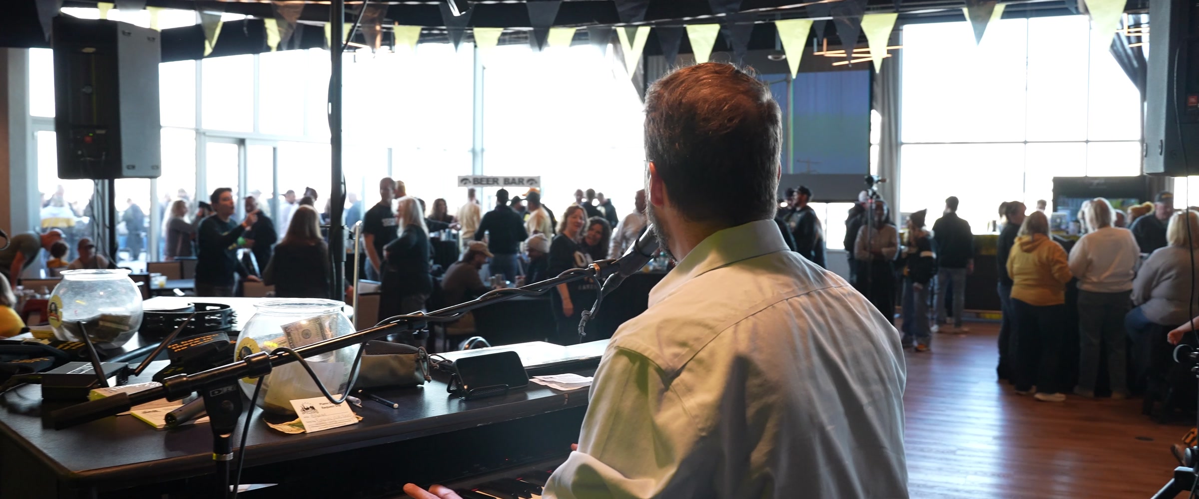 View from behind the piano of guests gathered for a Midwest Dueling Pianos show.