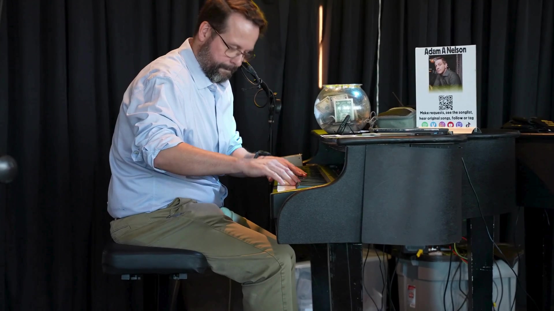 Midwest Dueling Pianos performer looking down at the keys while playing piano.